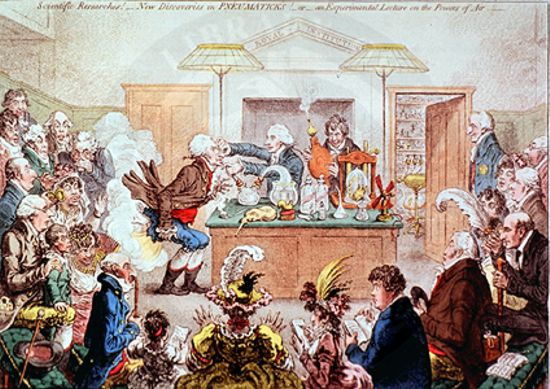 Conferencia experimental en la Royal Institution. El conde Rumford está de pie en el extremo derecho y Humphry Davy sostiene el fuelle